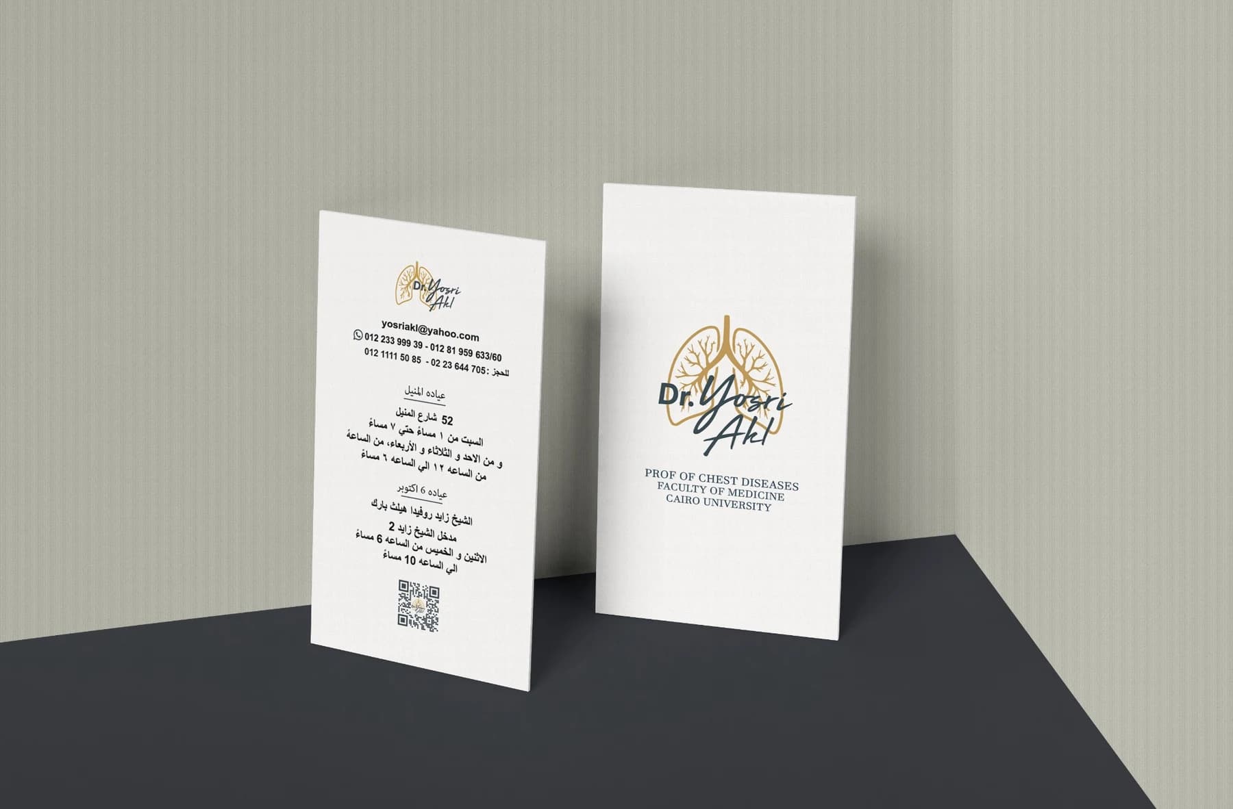 Front and back Dr. Yosri Akl clinic cards standing in a neutral mockup scene